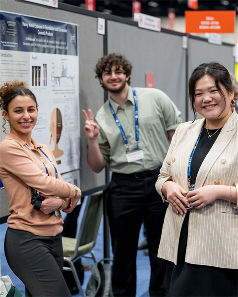 3 individuals smiling at the camera.